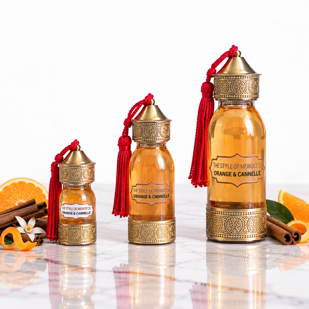 Set van drie geurolieflessen Orange & Cannelle in 30 ml, 60 ml en 125 ml op lichte studio-achtergrond